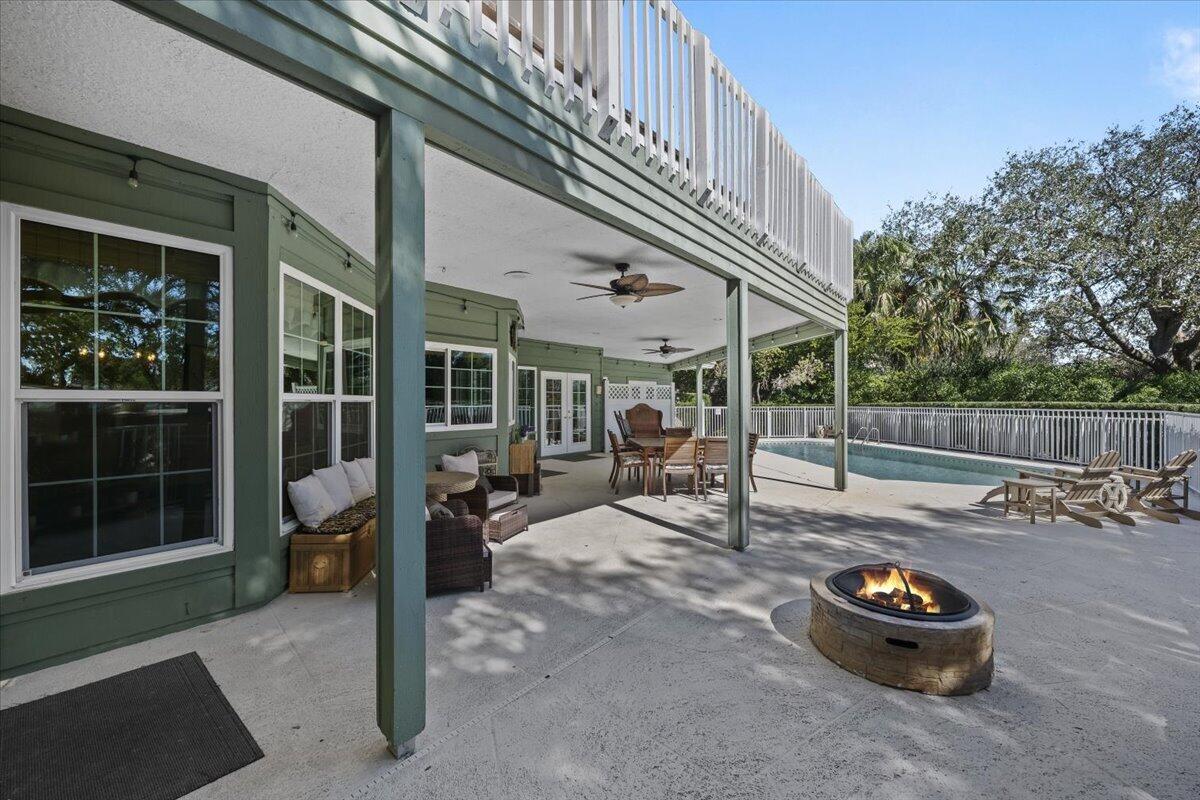 7 Alnwick Road Palm Beach Gardens, FL 33418 - Photo 32 of 47 a backyard of a house with barbeque oven and outdoor seating