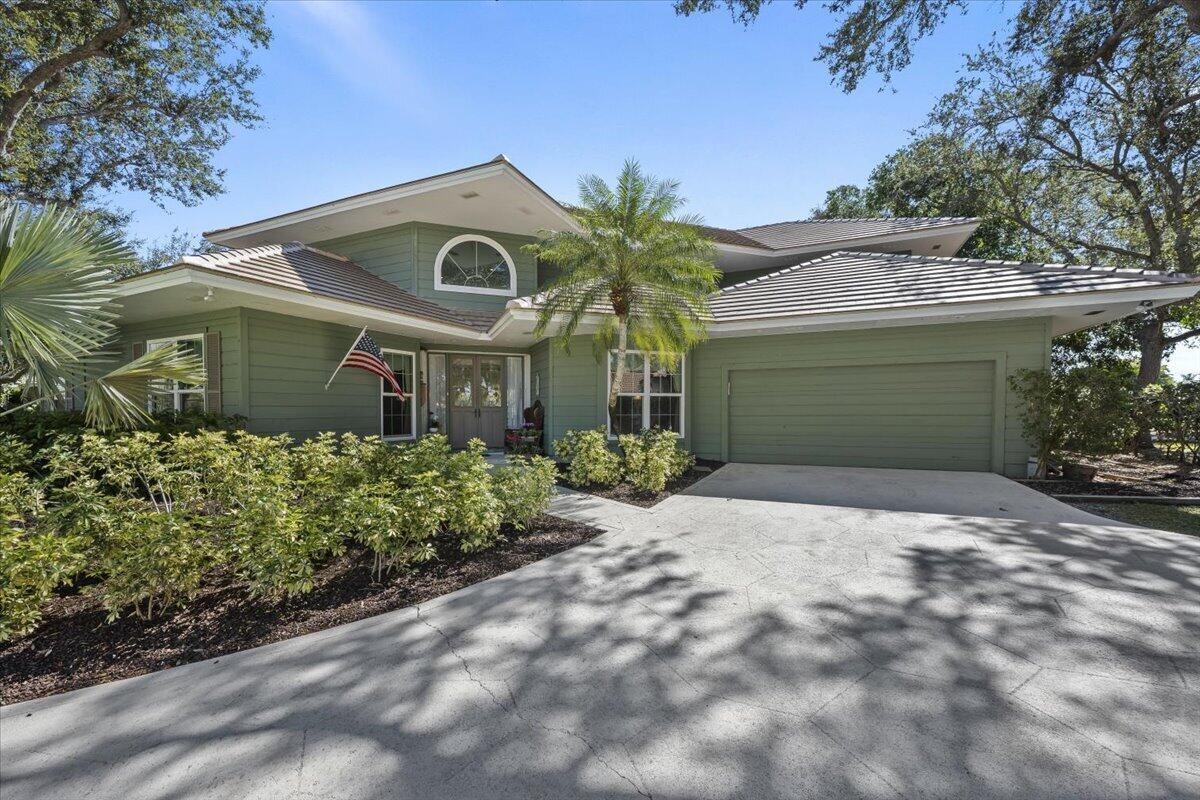 7 Alnwick Road Palm Beach Gardens, FL 33418 - Photo 43 of 47 a front view of a house with a garden