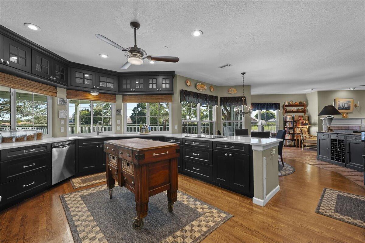 7 Alnwick Road Palm Beach Gardens, FL 33418 - Photo 7 of 47 a kitchen with stainless steel appliances granite countertop sink stove and wooden cabinets