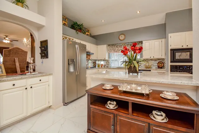 a kitchen with stainless steel appliances granite countertop a stove and a refrigerator