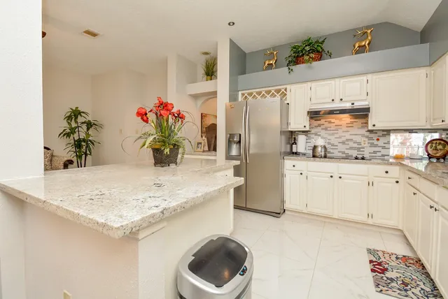 a kitchen with stainless steel appliances kitchen island granite countertop a sink and cabinets