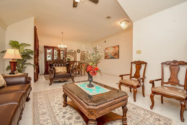 a living room with furniture a rug and white walls