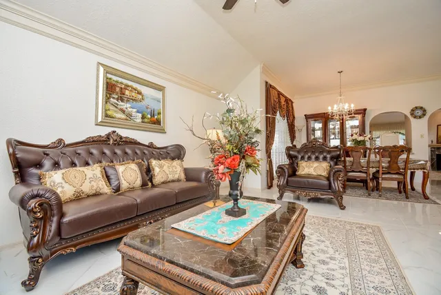 a living room with furniture and a chandelier