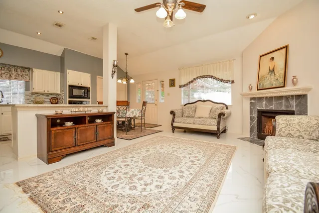 a living room with furniture and a fireplace