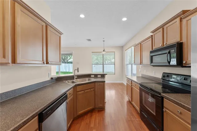 a kitchen with stainless steel appliances a sink stove and microwave