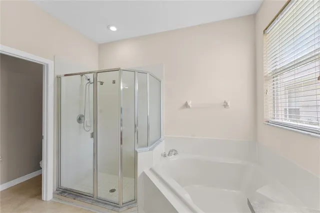 a bathroom with a shower and a tub
