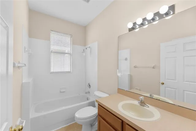 a bathroom with a sink toilet tub and shower