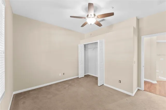 an empty room with a fan and a fan
