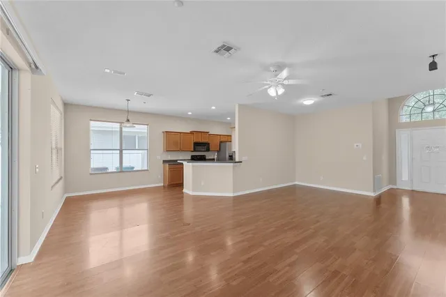 a view of kitchen with kitchen island wooden floor and window