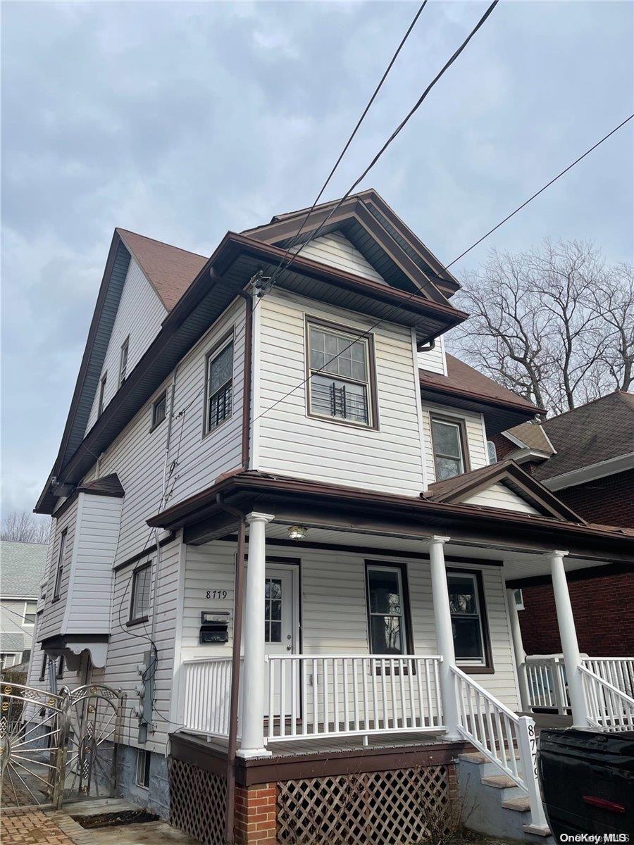 87-79 97th Street Queens, NY 11421 - Photo 1 of 1 a view of a white house with large windows