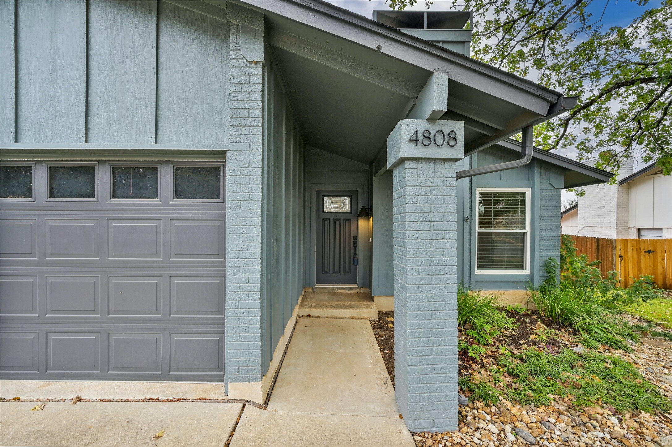 4808 Wind River Road Austin, TX 78759 - Photo 2 of 21 An inviting covered entryway leads directly to the front door alongside a attached garage.