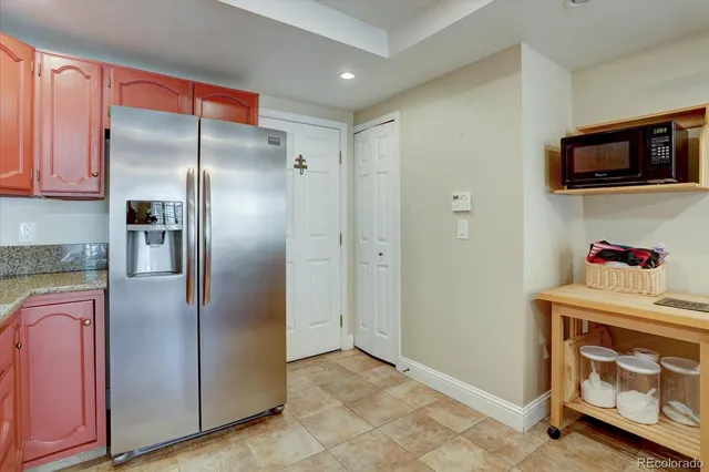 a kitchen with stainless steel appliances granite countertop a refrigerator and a stove