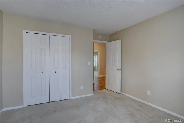 a view of an empty room and closet area