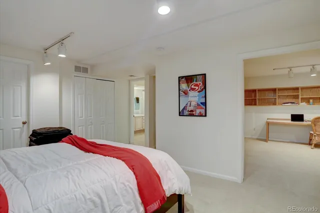 a bedroom with a bed and a view of kitchen