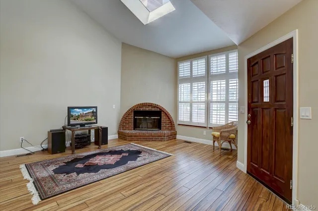 a living room with furniture window and wooden floor
