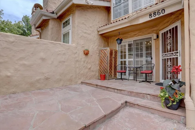 a view of a house with potted plants