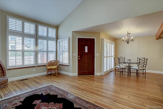 a view of a dining room with furniture and wooden floor