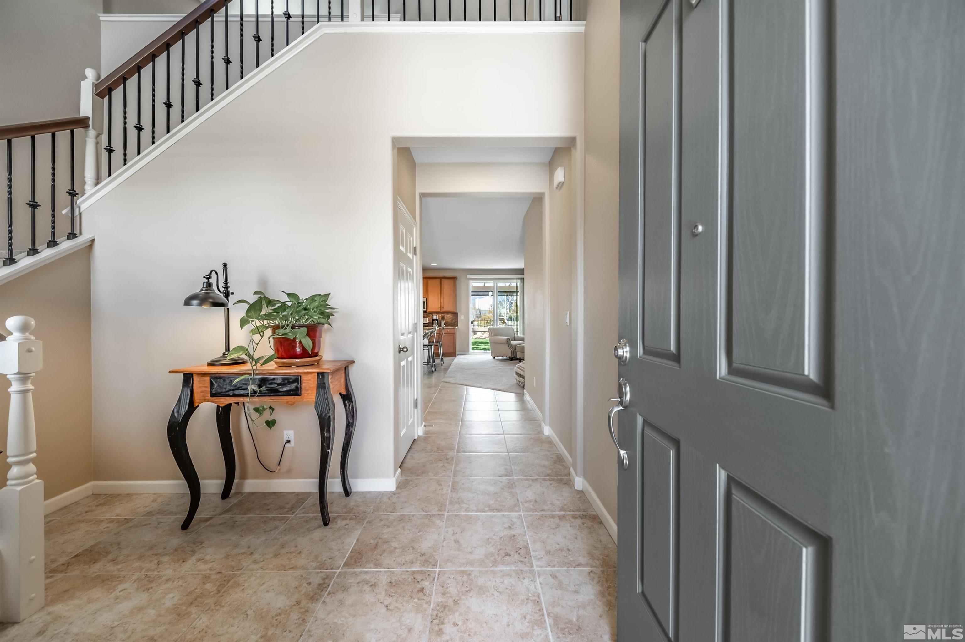 9375 Spotted Horse Road Reno, NV 89521 - Photo 3 of 33 a view of a hallway to a livingroom with furniture