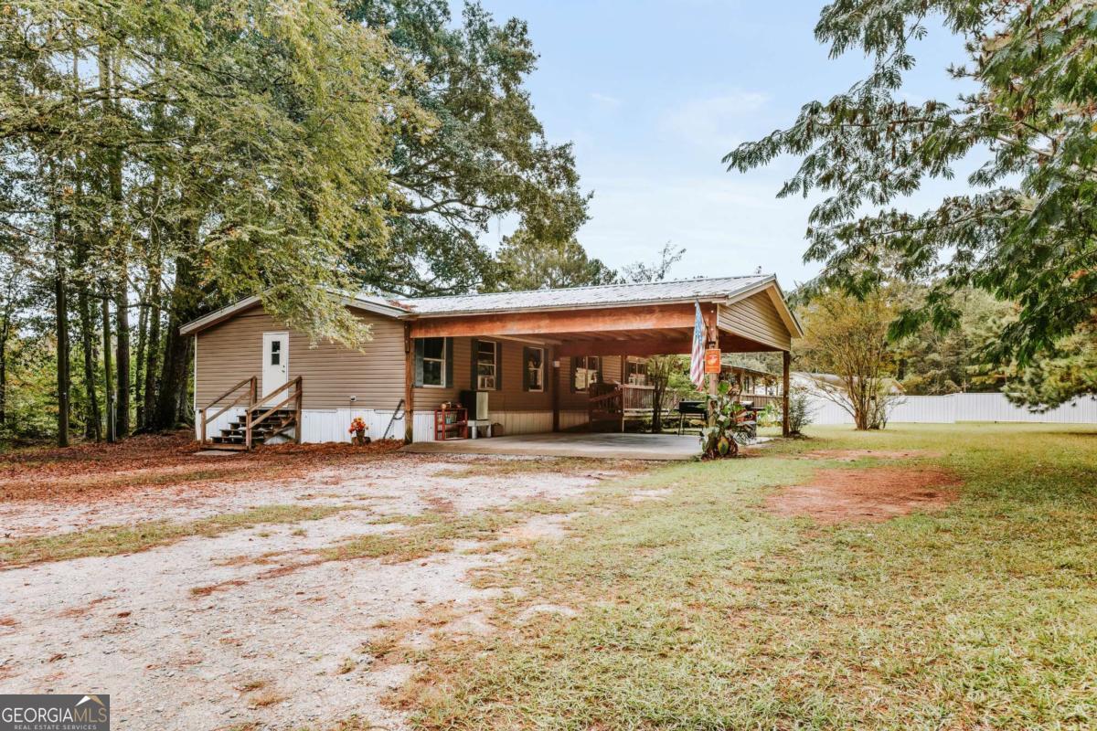 5971 Penfield Road Union Point, GA 30669 - Photo 1 of 42 a view of a house with a yard covered in snow