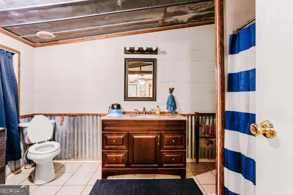 a bathroom with a sink a toilet and mirror