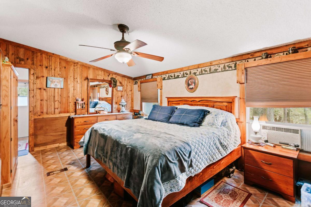 5971 Penfield Road Union Point, GA 30669 - Photo 17 of 42 a bedroom with a bed and window