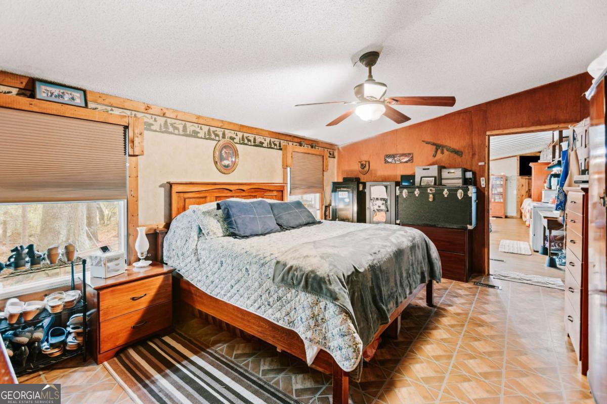 5971 Penfield Road Union Point, GA 30669 - Photo 18 of 42 a bed sitting in a bedroom next to a window