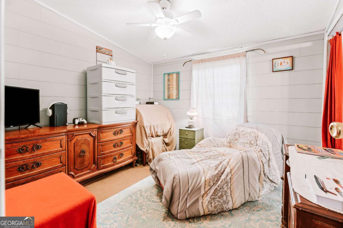 5971 Penfield Road Union Point, GA 30669 - Photo 19 of 42 a bedroom with two beds and painting on the wall