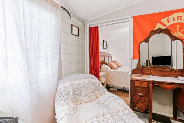 a bedroom with a bed and a fireplace