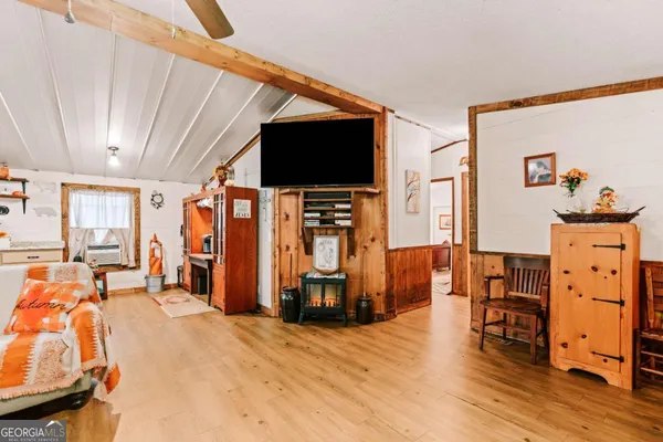 a bedroom with furniture and a flat screen tv