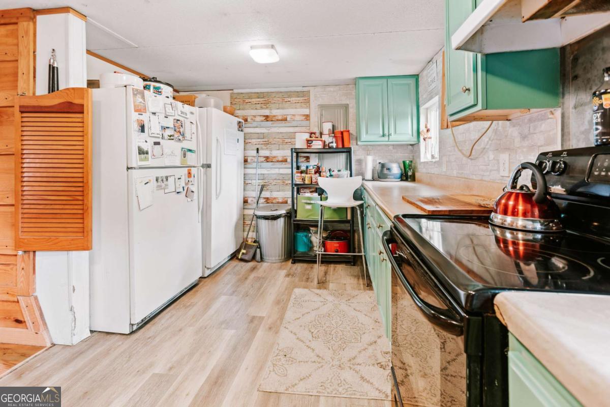 5971 Penfield Road Union Point, GA 30669 - Photo 31 of 42 a view of a kitchen with fridge and workspace