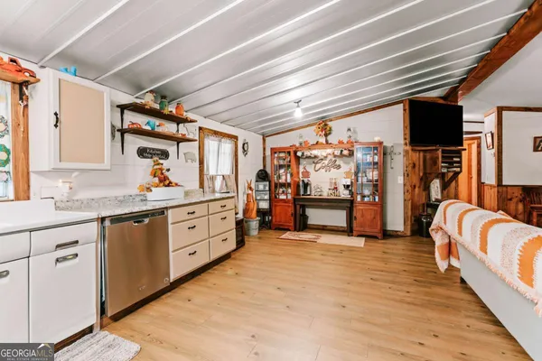 a large white kitchen with cabinets