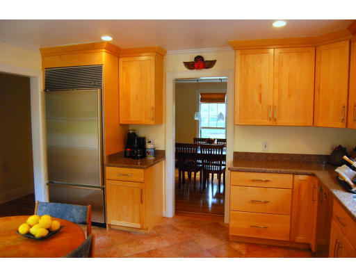 244 Bonad Road Brookline, MA 02467 - Photo 5 of 13 a kitchen with stainless steel appliances granite countertop a refrigerator and a stove top oven