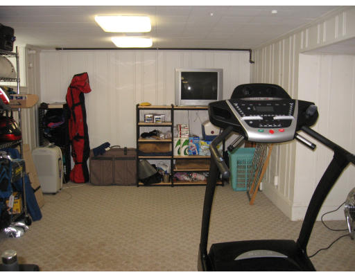 244 Bonad Road Brookline, MA 02467 - Photo 8 of 13 a bedroom with furniture and a gym equipment