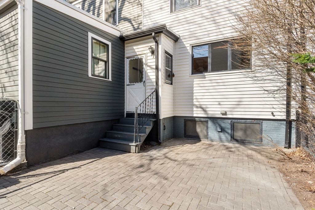 56 Spring Street, Unit 56 Cambridge, MA 02141 - Photo 14 of 15 a front view of a house with a yard