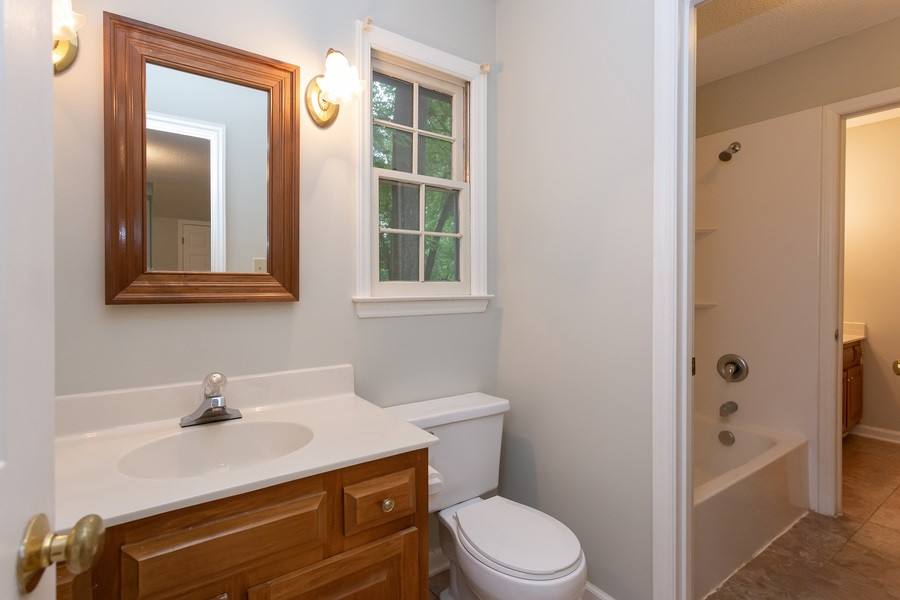 6917 Sandringham Drive Raleigh, NC 27613 - Photo 14 of 25 Tub is located just a few steps away which sits between both sinks and toilets, perfect for his and her or roommate situation! Master Bath