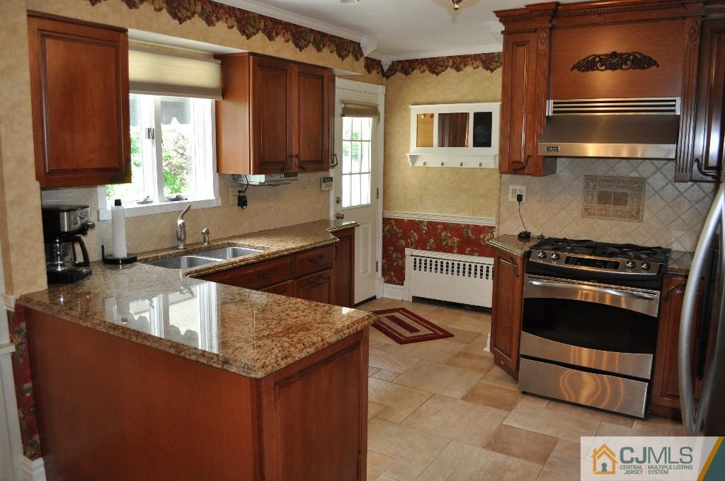 110 Stafford Road Colonia, NJ 07067 - Photo 2 of 24 a kitchen with a sink stove and microwave