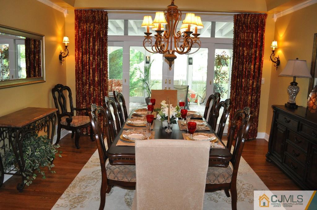 110 Stafford Road Colonia, NJ 07067 - Photo 12 of 24 a view of a dining room with furniture a chandelier and wooden floor