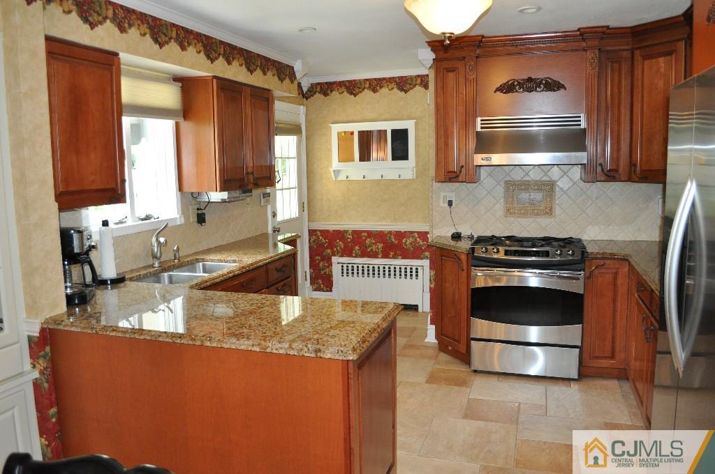 110 Stafford Road Colonia, NJ 07067 - Photo 13 of 24 a kitchen with stainless steel appliances granite countertop a stove and a sink