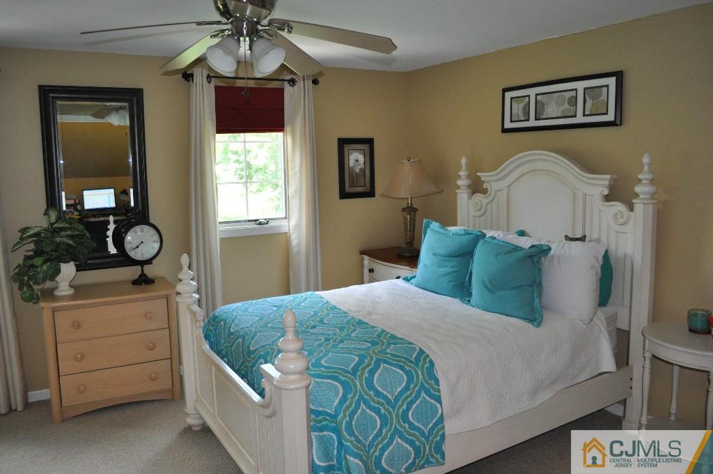 110 Stafford Road Colonia, NJ 07067 - Photo 22 of 24 a bedroom with a bed and a chandelier