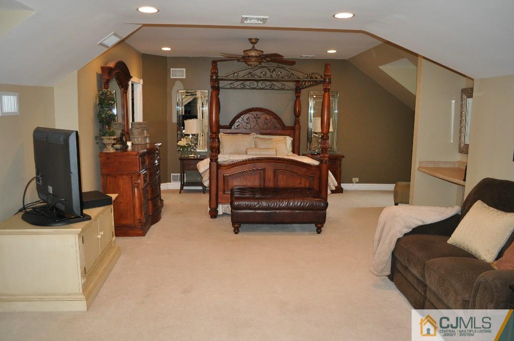 110 Stafford Road Colonia, NJ 07067 - Photo 4 of 24 a living room with furniture a flat screen tv and a fireplace