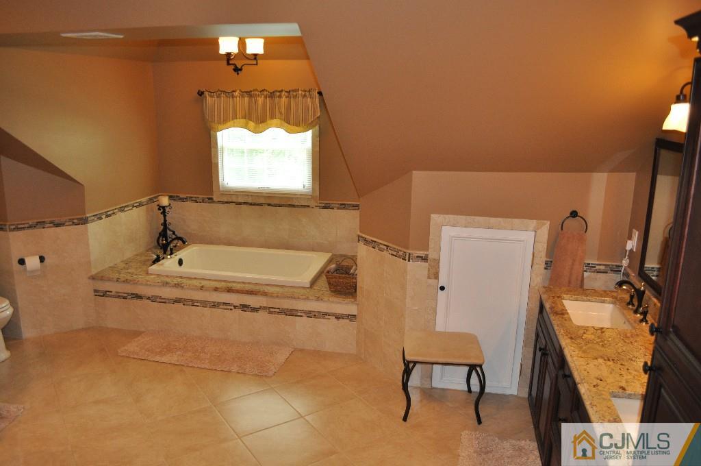110 Stafford Road Colonia, NJ 07067 - Photo 5 of 24 a bathroom with a tub sink and mirror
