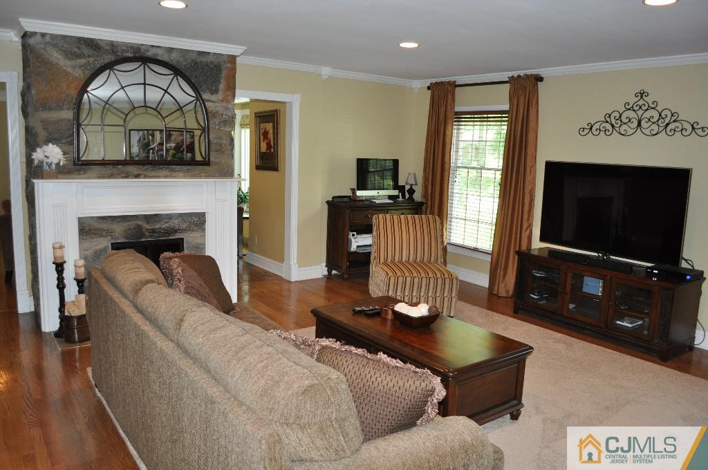 110 Stafford Road Colonia, NJ 07067 - Photo 7 of 24 a living room with furniture a flat screen tv and a fireplace