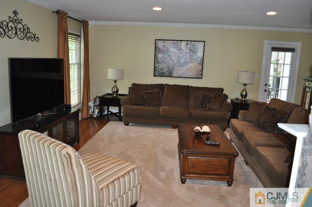 110 Stafford Road Colonia, NJ 07067 - Photo 9 of 24 a living room with furniture a flat screen tv and a window