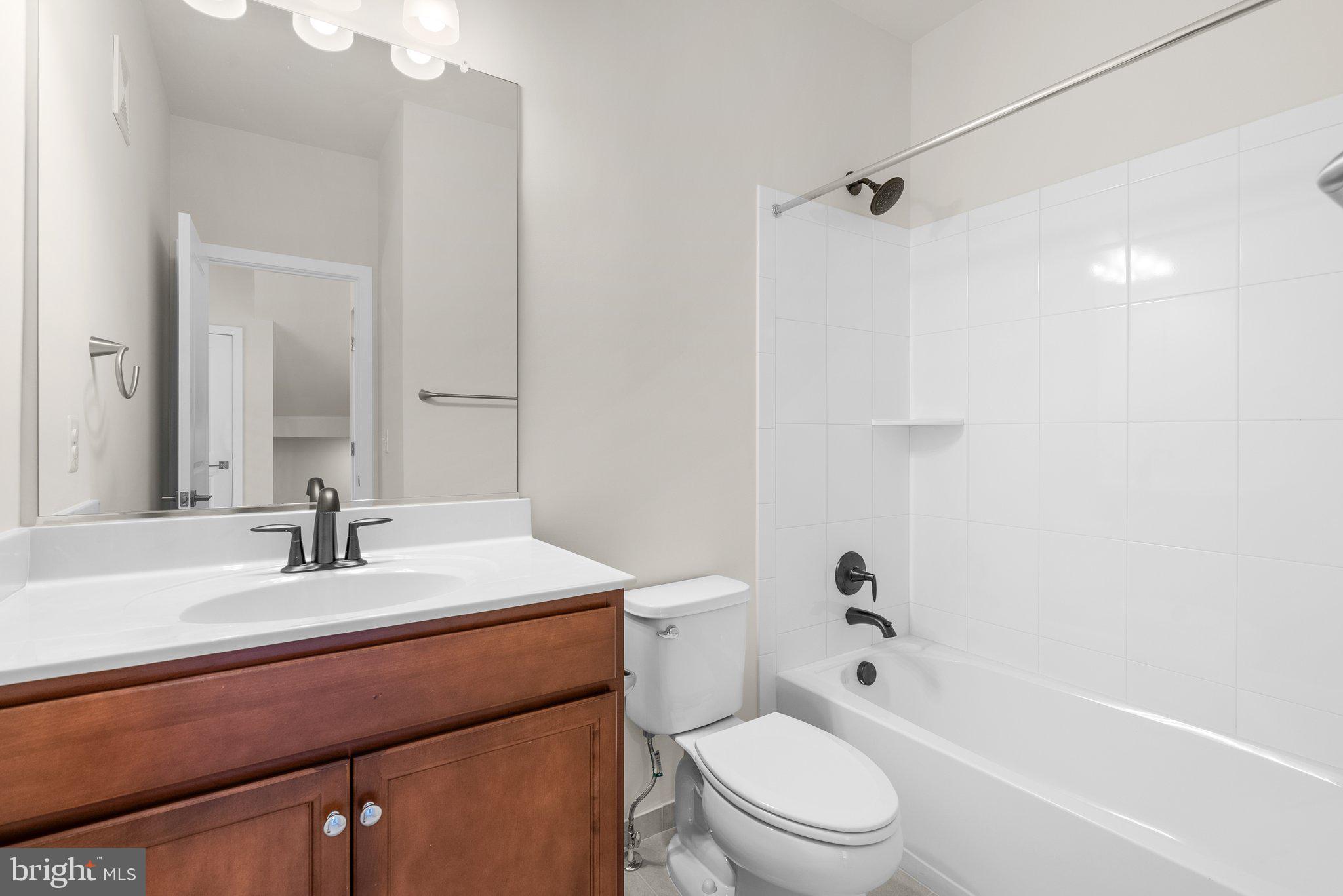 43176 Farringdon Square Broadlands, VA 20148 - Photo 15 of 33 a bathroom with a sink a toilet a mirror and shower