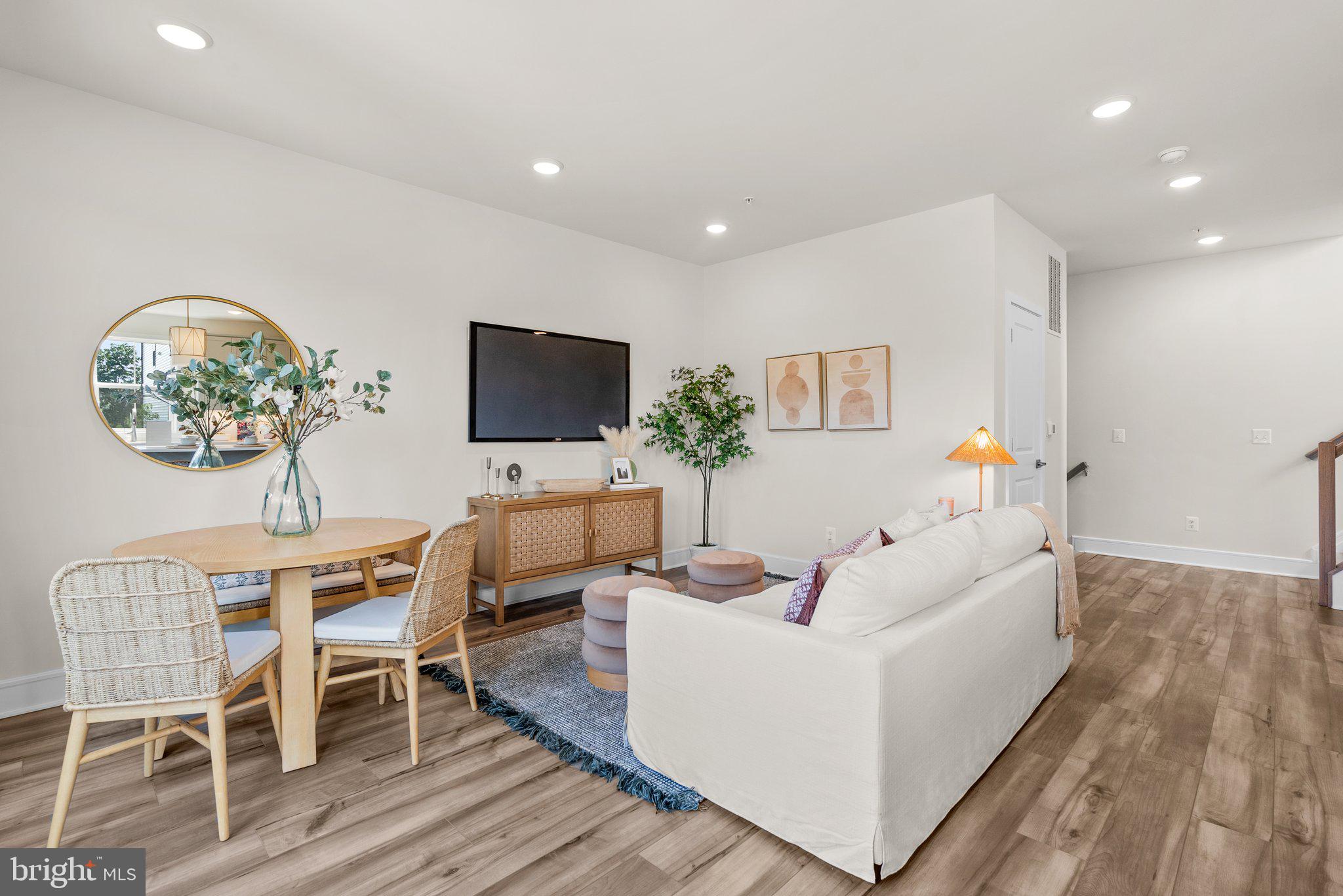 43176 Farringdon Square Broadlands, VA 20148 - Photo 2 of 33 a living room with furniture and a flat screen tv