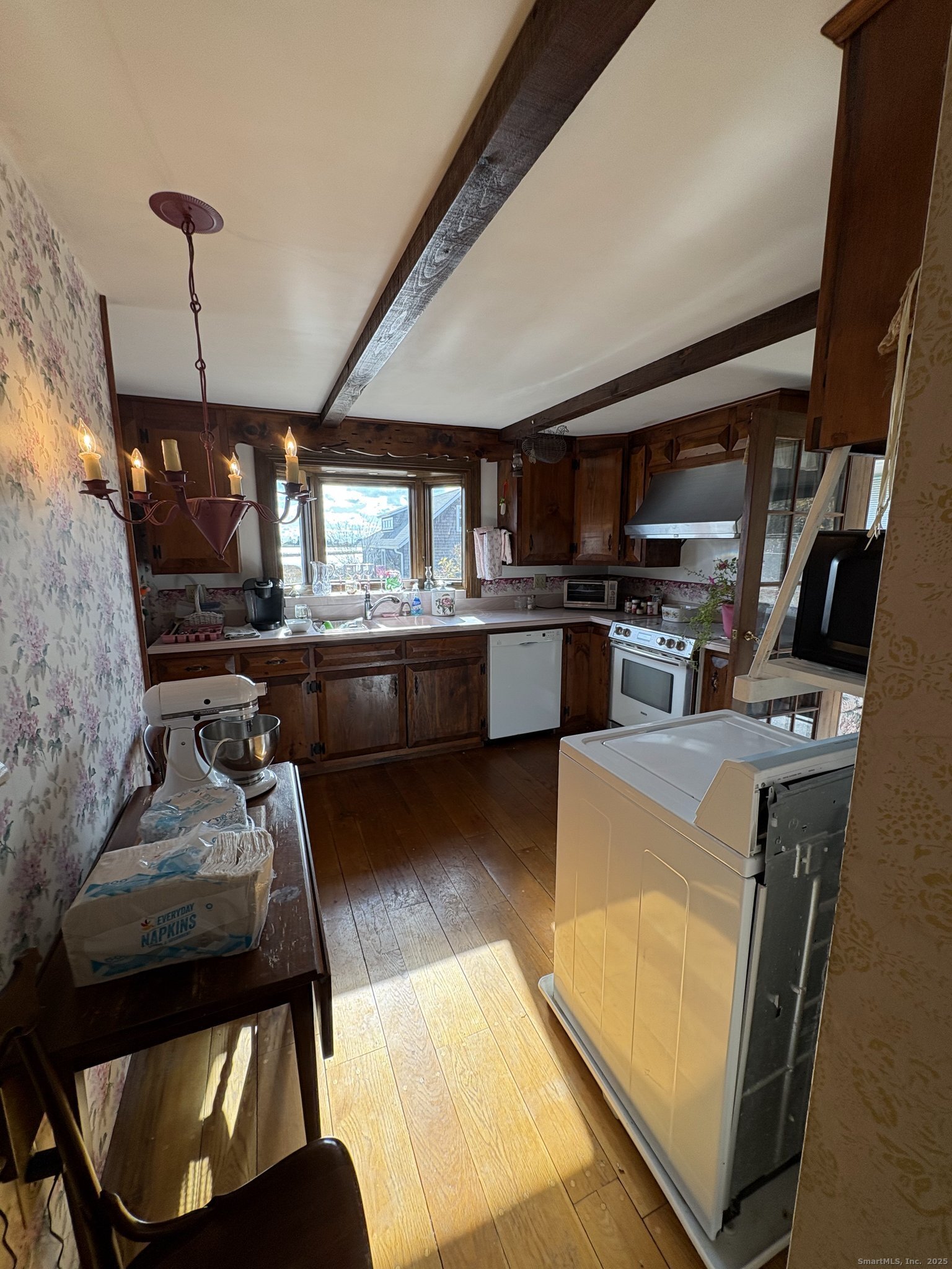 21 Fenwick Street Old Saybrook, CT 06475 - Photo 8 of 15 a kitchen with microwave a stove and furniture