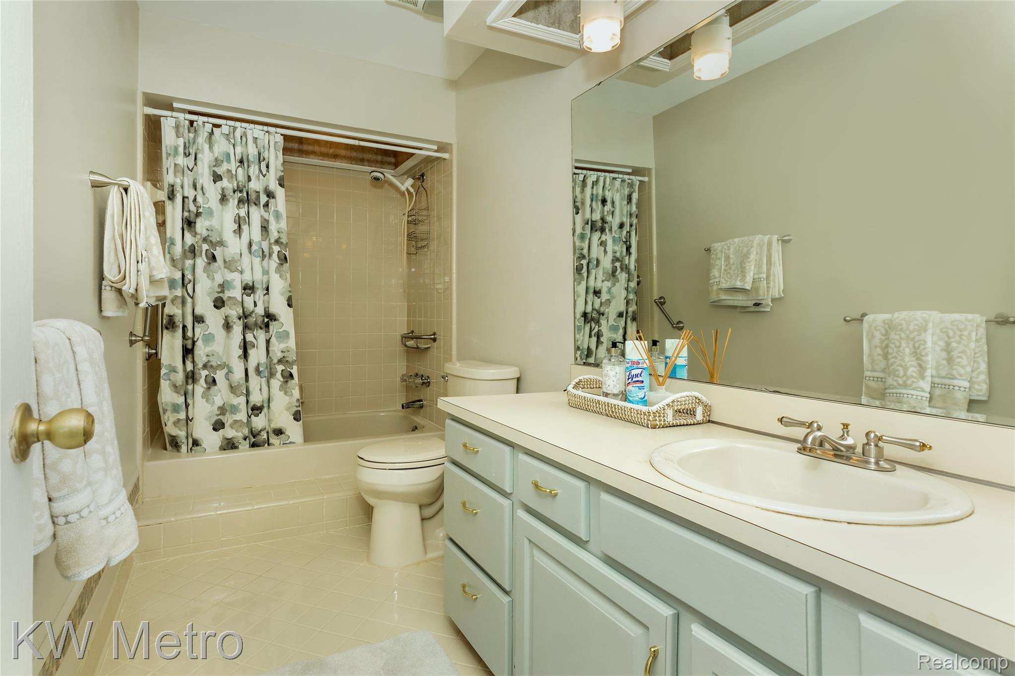 2154 Warrington Road Rochester, MI 48307 - Photo 27 of 41 Bathroom featuring a single vanity with a laminate countertop, light blue cabinetry, and a framed mirror