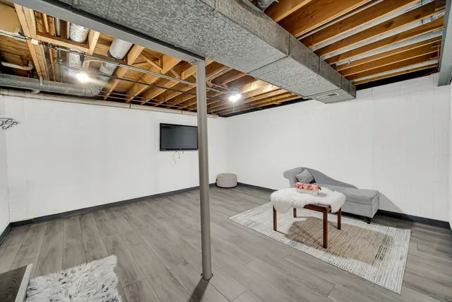 a living room with wooden floor and furniture