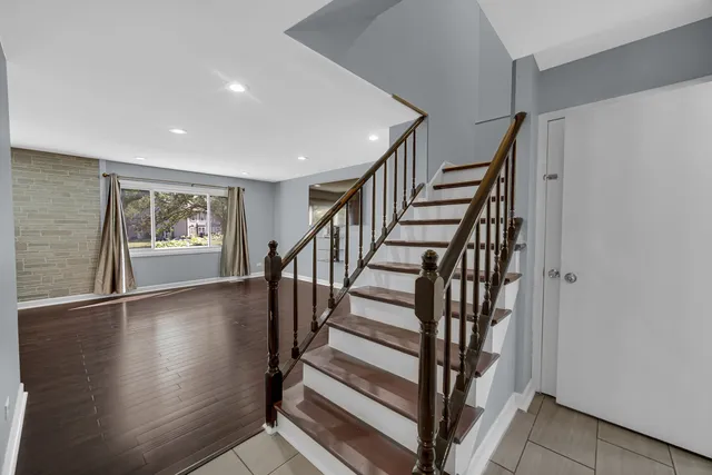 a view of entryway with wooden floor and stairs