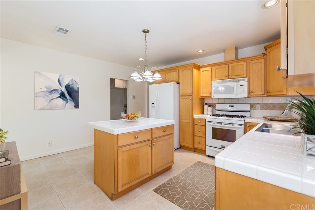 610 Del Monte Street Pasadena, CA 91103 - Photo 18 of 49 a kitchen that has a lot of cabinets in it and wooden floors